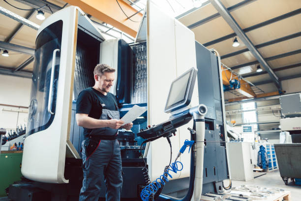 istock Worker in metal industry operating a modern cnc lathe 1279667951