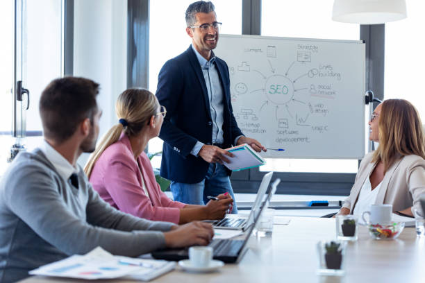 istock Handsome businessman explaining a project to his colleagues on coworking place. 1279668585