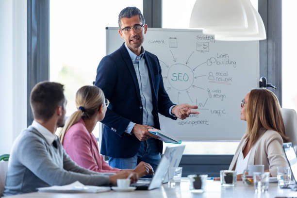 istock Handsome businessman explaining a project to his colleagues on coworking place. 1279668772