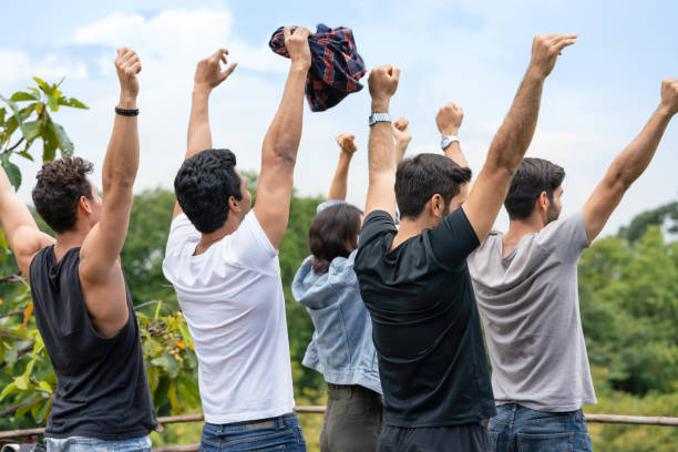 istock Happy group of friends happy fun hands raised together looking forward to mountain view while traveling adventure on holidays 1279669309