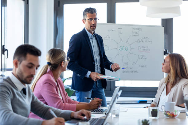 istock Handsome businessman explaining a project to his colleagues on coworking place. 1279671099