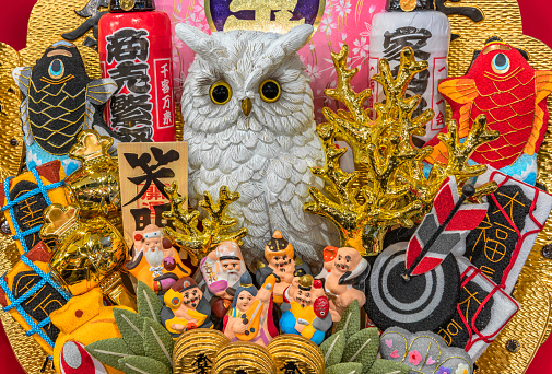 asakusa, japan - november 08 2019: Auspicious rake of Tori-no-Ichi Fair decorated with lucky charms like owl, golden coral,sea breams,fortune mallet or seven lucky gods for having success in business.