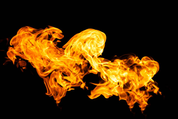 istock Fire flames on black background isolated. Burning gas or gasoline burns with fire and flames. Flaming burning sparks close-up, fire patterns. Infernal glow of fire in the dark with copy-space 1279675406