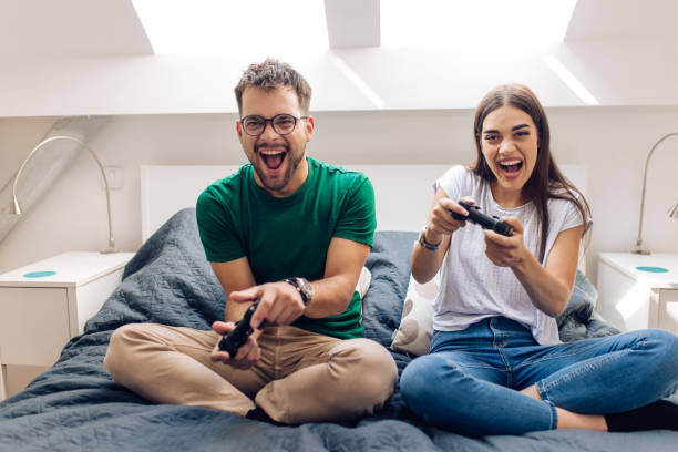 istock Happy young couple playing video games 1279675743