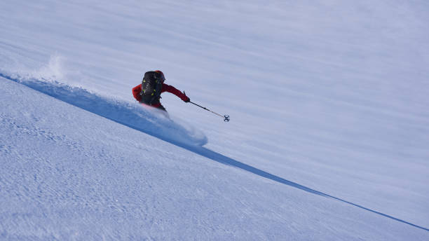 istock Back country skier skiing first track in powder snow. 1279676530