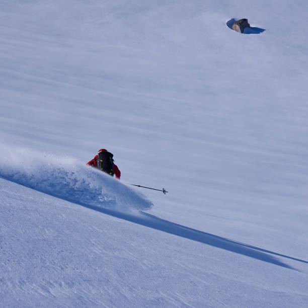 istock Back country skier skiing first track in powder snow. 1279676546
