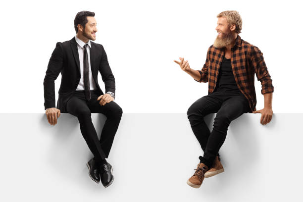 istock Young casual bearded man and a businessman sitting on a panel and having a conversation 1279677914