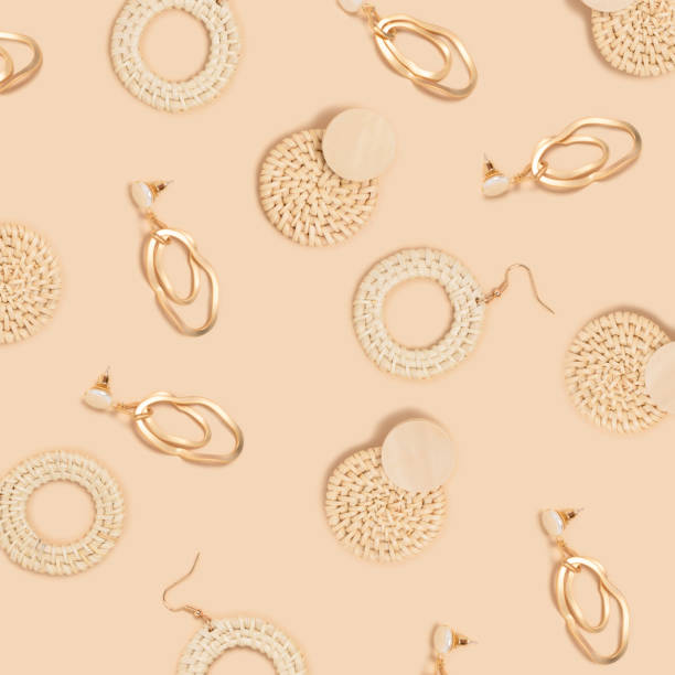istock Pattern made of earrings on a beige background. 1279678023