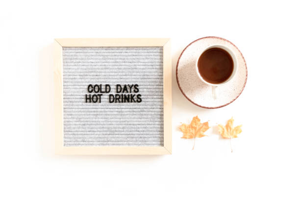 istock Quote Cold days hot drinks. Composition with letterboard, mug of coffee, dried maple leaves 1279678338