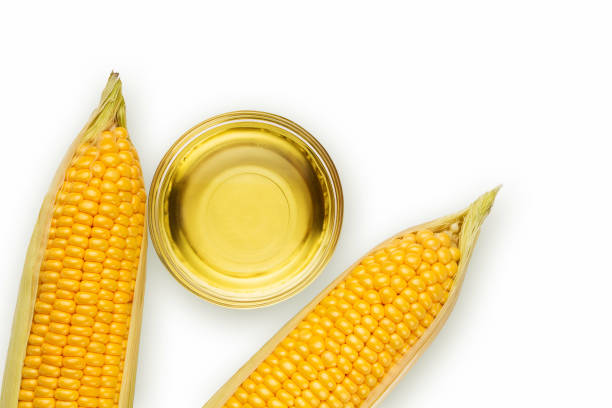 istock Corn oil in a bowl and corn cobs on a white background 1279682568