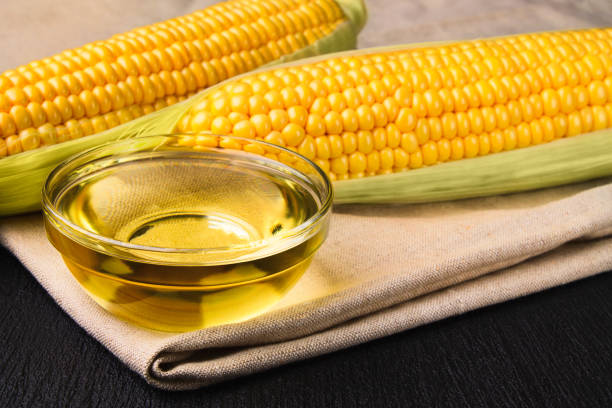 istock Fresh corn oil in a bowl with ears of corn 1279682648