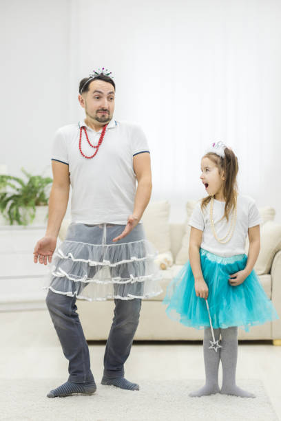 istock Father and his little daughter dancing against white background. 1279683988