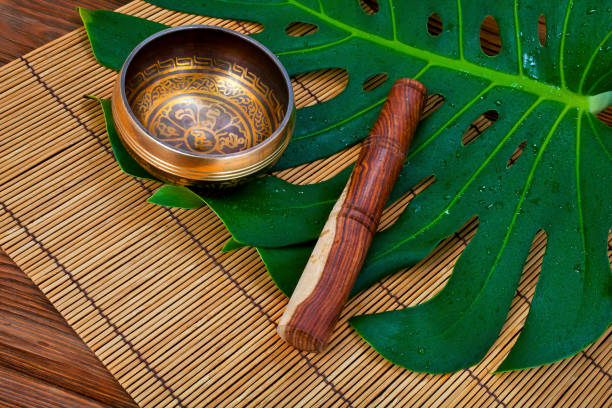 istock Tibetan singing bowl with leaf on a bamboo napkin 1279684376