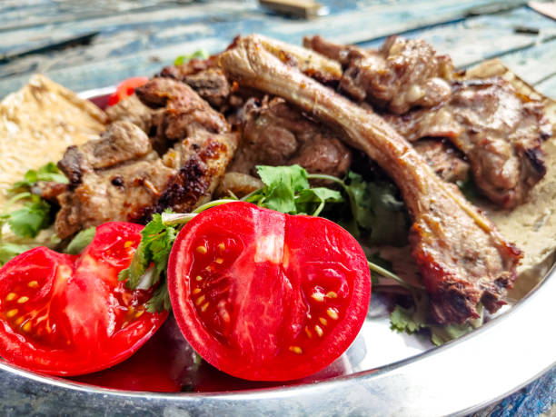 istock Grilled lamb loin with tomatoes and herbs is on a platter 1279685592