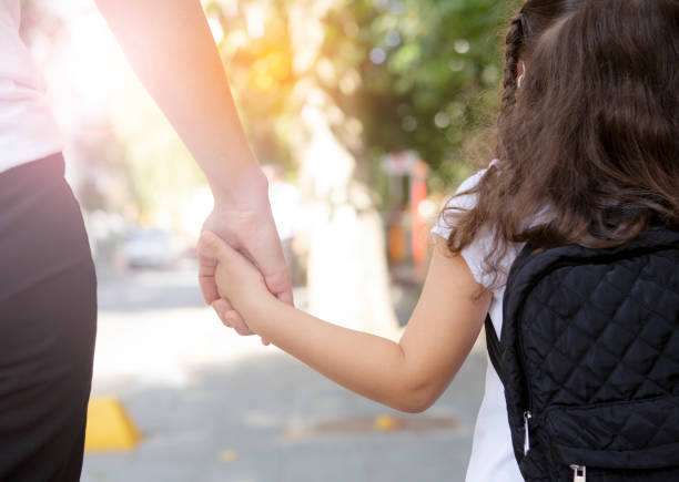istock Mother taking her daughter to school 1279687682