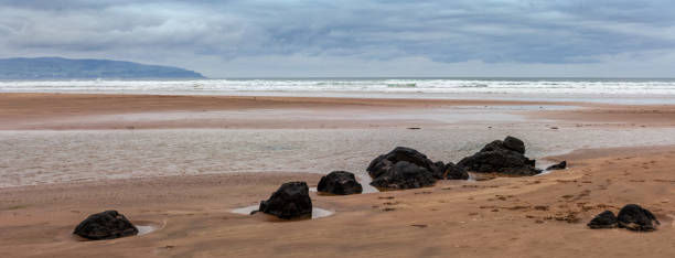 warstwy przypływu i grzbiet dużych kamieni na downhill beach w downhill w hrabstwie londonderry w irlandii północnej. lokalizacja gry o tron fotografowania - coleraine zdjęcia i obrazy z banku zdjęć