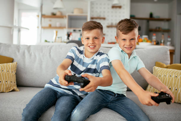 istock Happy brothers playing video games. 1279690631