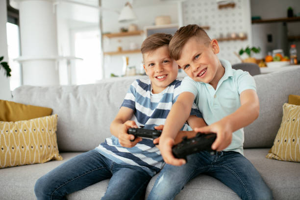 istock Happy brothers playing video games. 1279690632