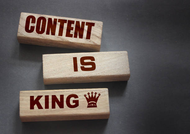 Content is king words on wooden blocks on dark grey background. Copywriting storytelling concept