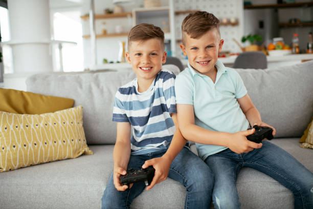 istock Happy brothers playing video games. 1279691796