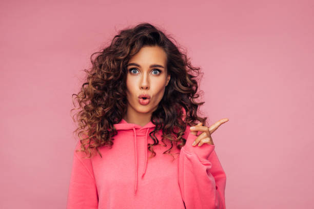 istock Beautiful surprised girl pointing away 1279693038