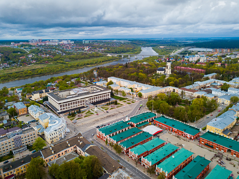 Scenic view from drone of Kaluga cityscape on Oka riverbanks with Holy Trinity Cathedral in cloudy spring day, Russia