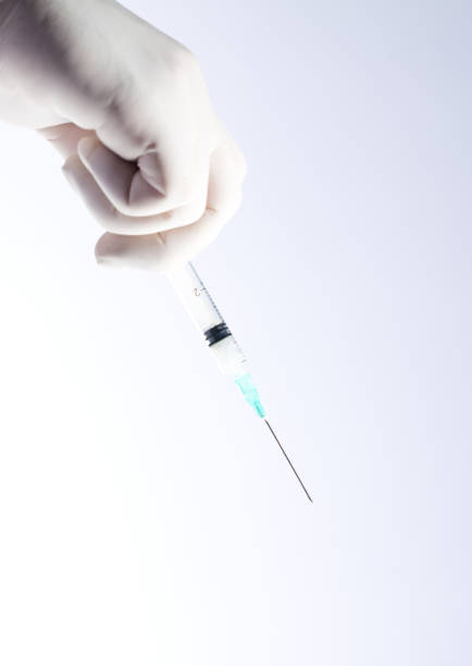 istock syringe in doctor's hand, white background 1279697328