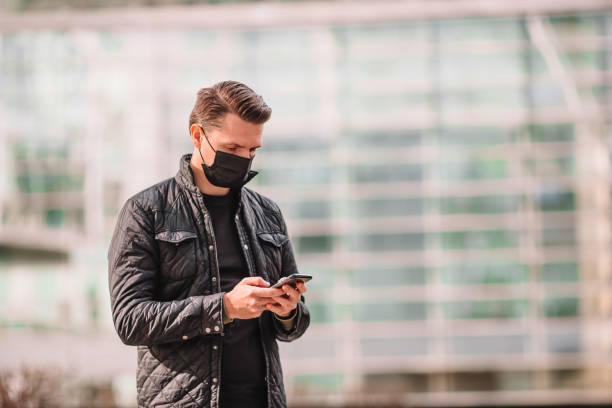 istock Man wearing a mask on a background of a modern building, 1279699155