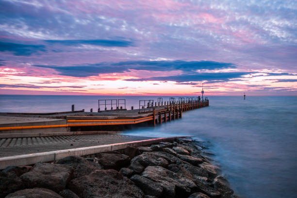 istock Scenic sunset over ocean and boat jetty - long exposure landscape 1279700375