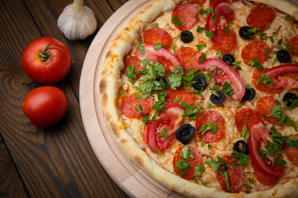 istock pizza with salami, cheese, tomatoes and herbs 1279700490