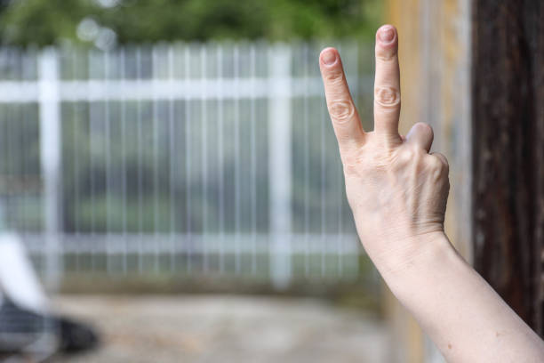 istock Hand with metal fence, feeling no freedom 1279701393