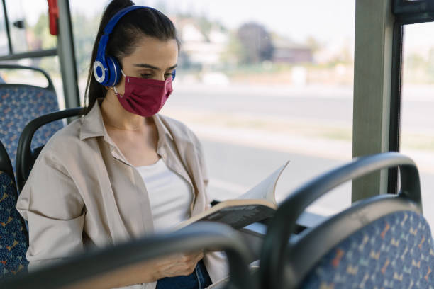 istock Young woman reading book in the bus 1279702691