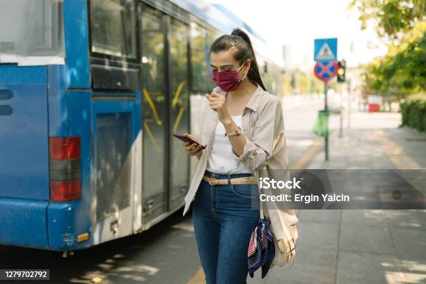 Portrait Of A Young Woman Wearing Protective Face Mask Waiting For The Bus Stock Photo - Download Image Now