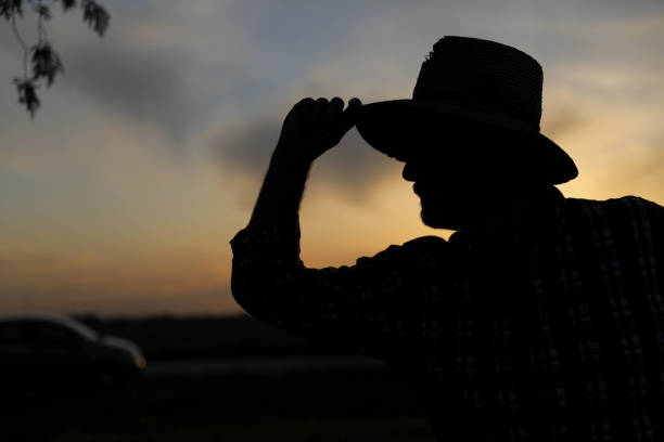 istock Farmer in straw hat in wheat field at sunset 1279703369
