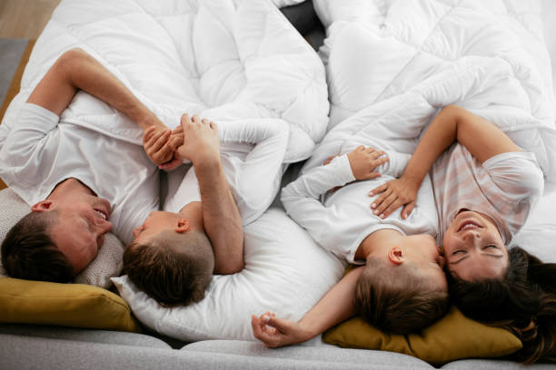 istock Happy parents with sons relaxing in bed. 1279704509