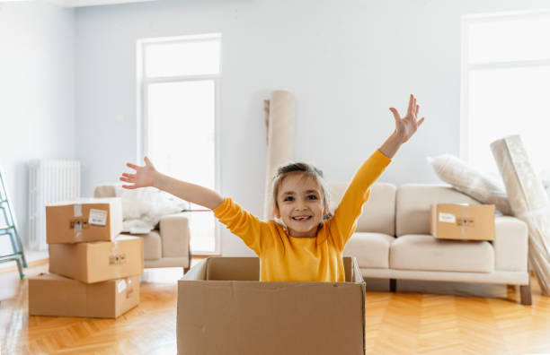 istock Laughing  little daughter playing with box 1279705401