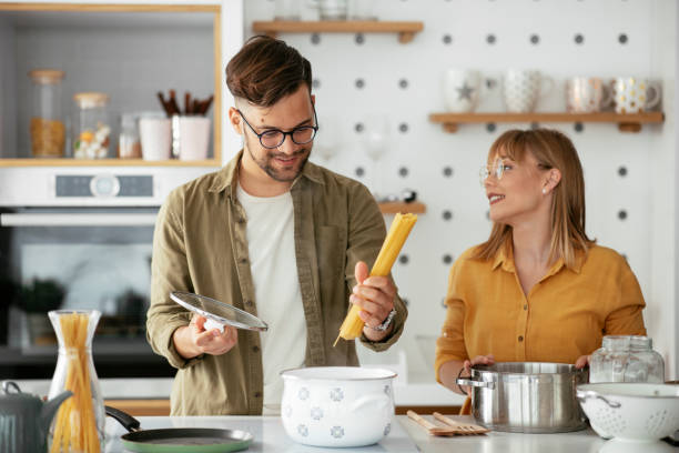 istock Boyfriend and girlfriend making pasta at home. 1279705451