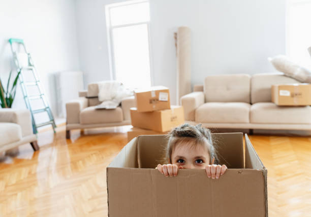 istock Laughing  little daughter playing with box 1279705473