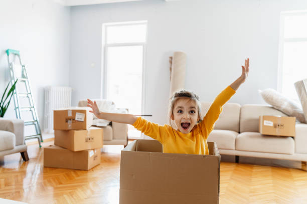 istock Laughing  little daughter playing with box 1279705509