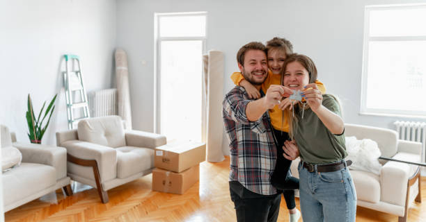 holding keys of their new home Excited American young family show keys to own home, happy  couple  buying first house together, smiling husband and wife purchase new property. Ownership concept new home stock pictures, royalty-free photos & images