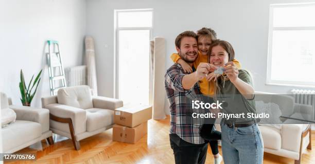 Holding Keys Of Their New Home Stock Photo - Download Image Now - Family, House, Moving House