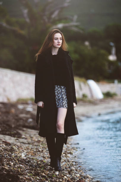 istock Lonely sad woman walking alone 1279708044