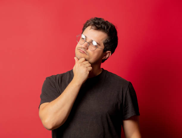 istock Man in glasses and shirt on red background 1279709149