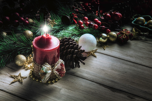 Christmas candle lights on rustic wooden table and copy space. Christmas themes.