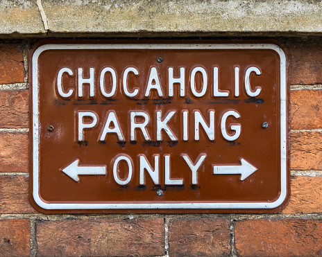 Close-up of a fun sign informing people that the parking spaces are for Chocaholics only.