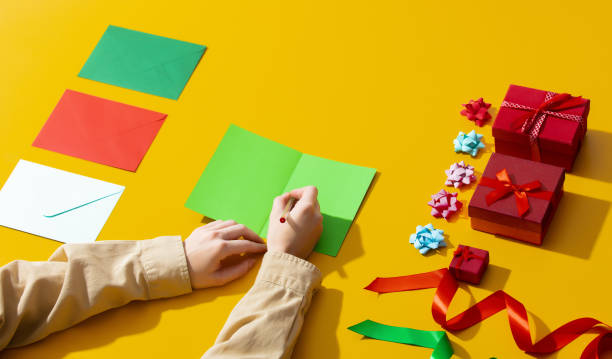 istock Female hand hold envelope near gifts 1279710807