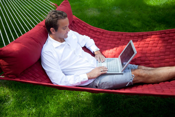 istock Man Working on Laptop at Home in a Hammock. 1279711764