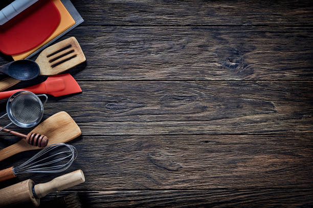istock Top view of wooden kitchen utensils on rustic table with copy space. 1279715471
