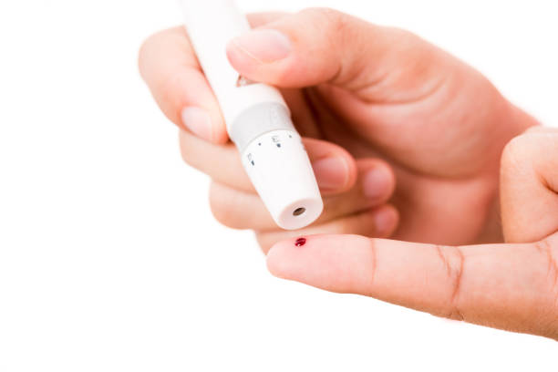 istock woman measuring glucose level using a hand test lancelet on the finger 1279716403