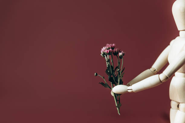 istock Wood man holding flowers 1279718358